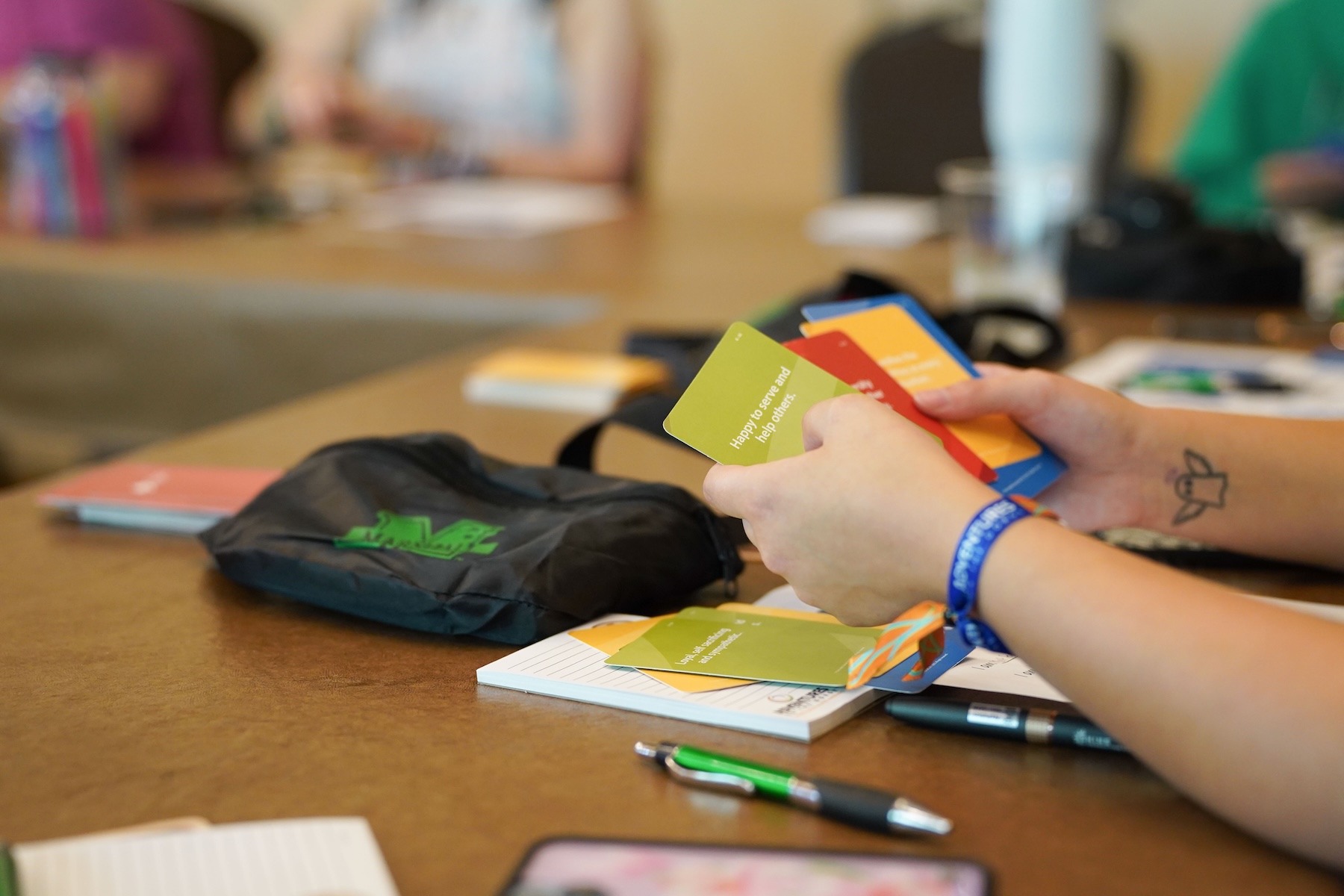 student holding four personality type cards