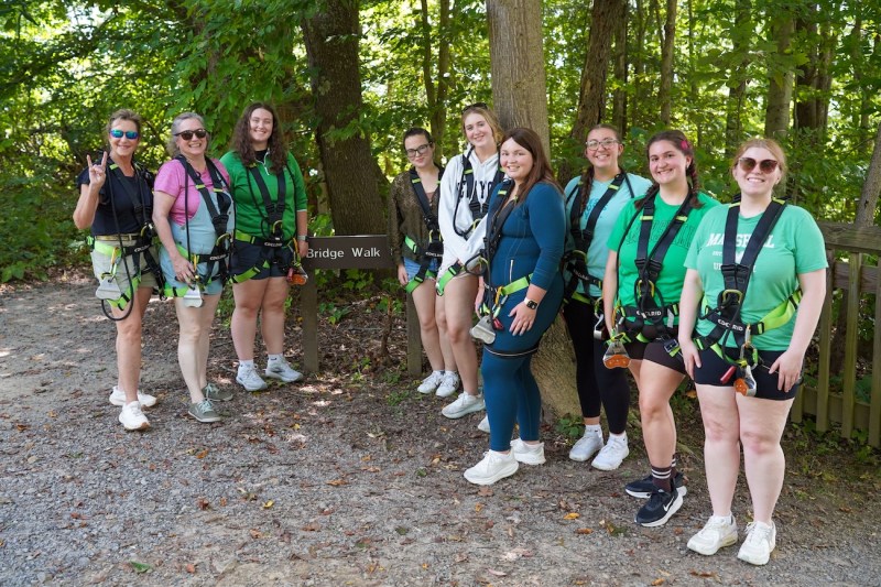 group of students smiling preparing to go on the New River Gorge Bridge Walk