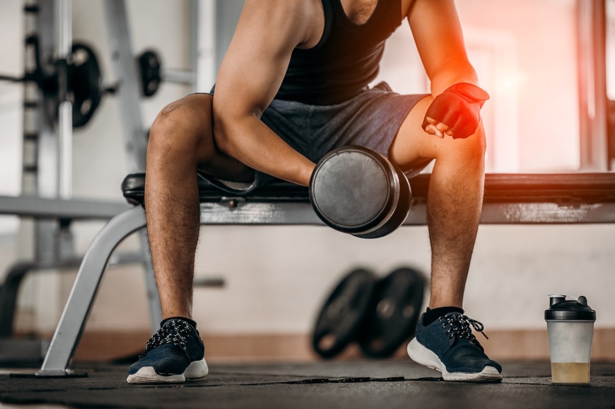 image of male lifting weights