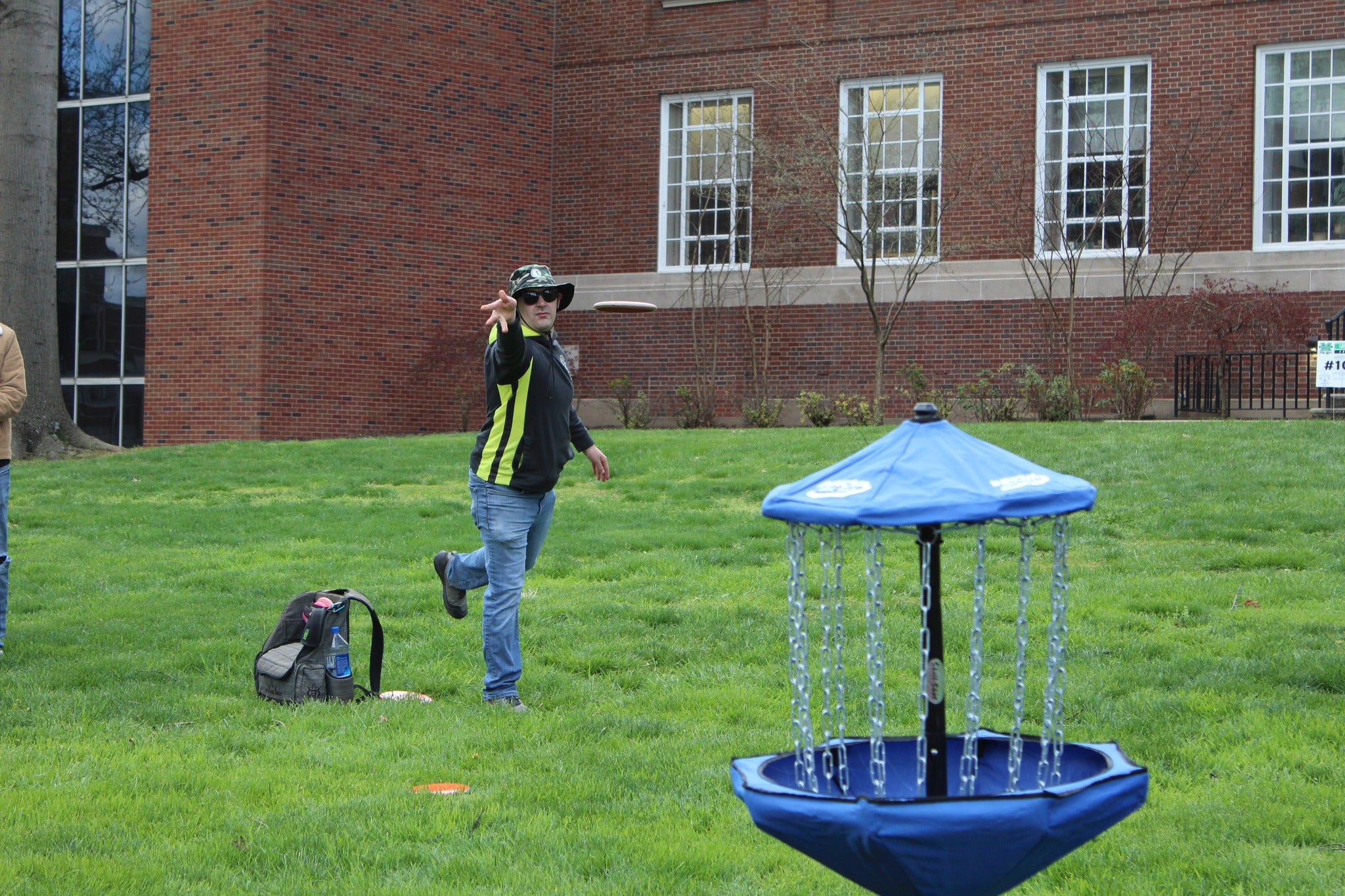 Image of male playing disc golf on campus