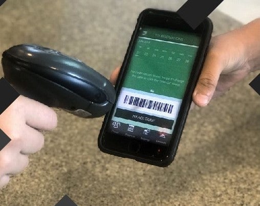 Image of a phone being scanned to enter rec