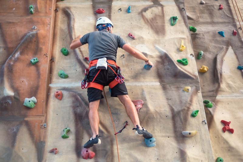 Image of male rock climbing at the rec