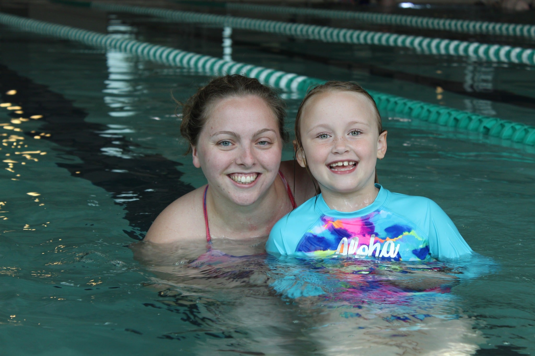 Image of a kid and swim instructor in rec pool