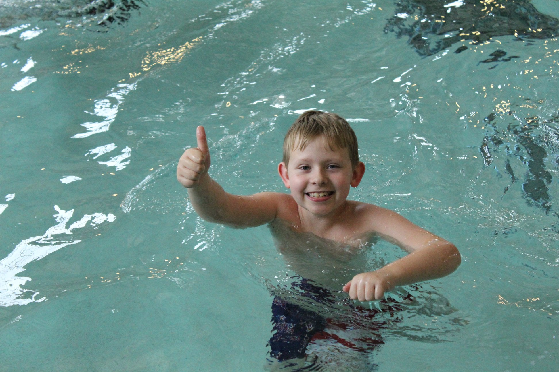 Image of young male in the pool