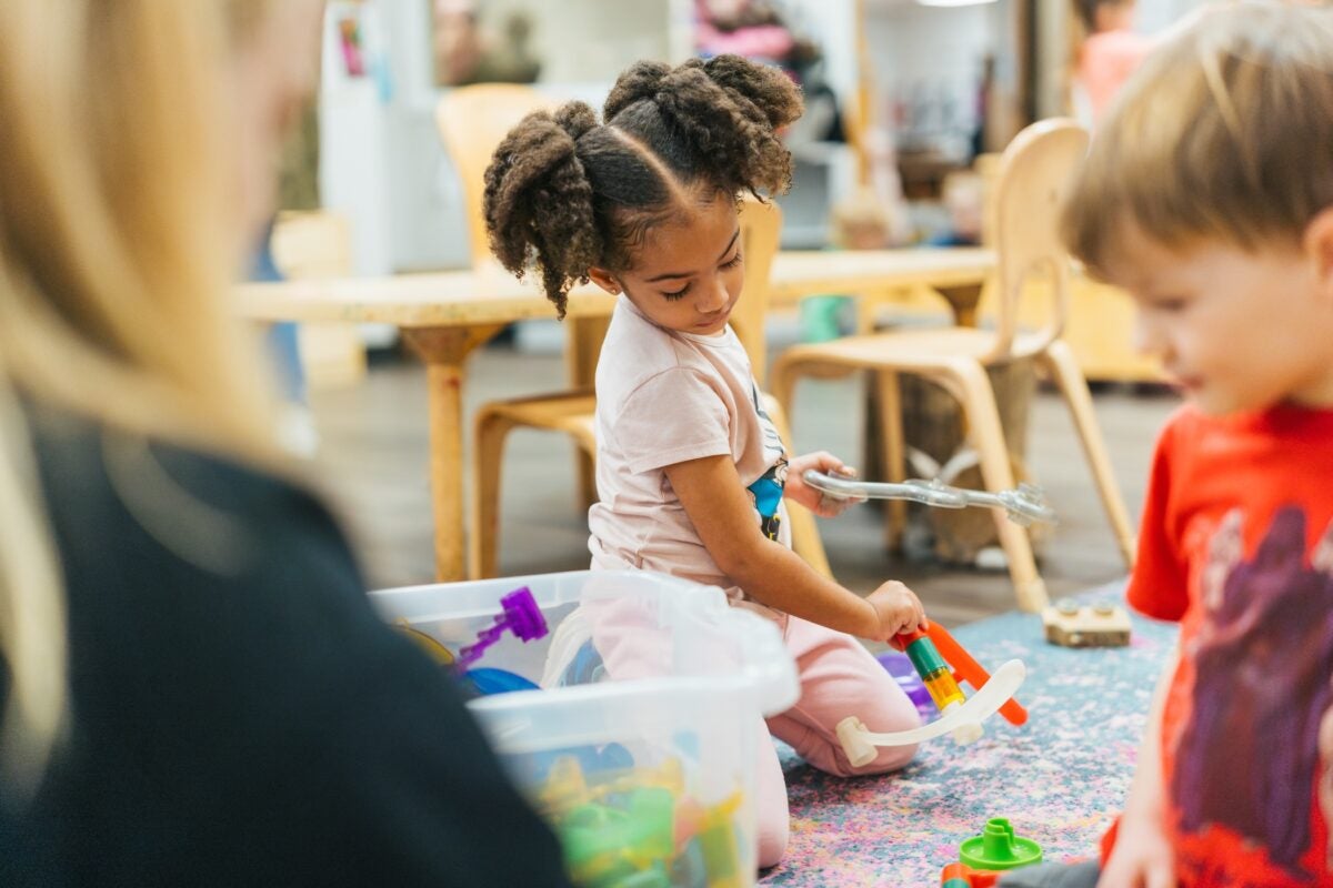 students playing on the floor in a classroom