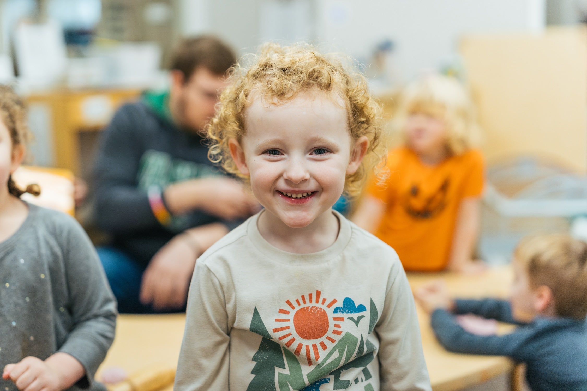 preschooler smiling at the camera in the classroom