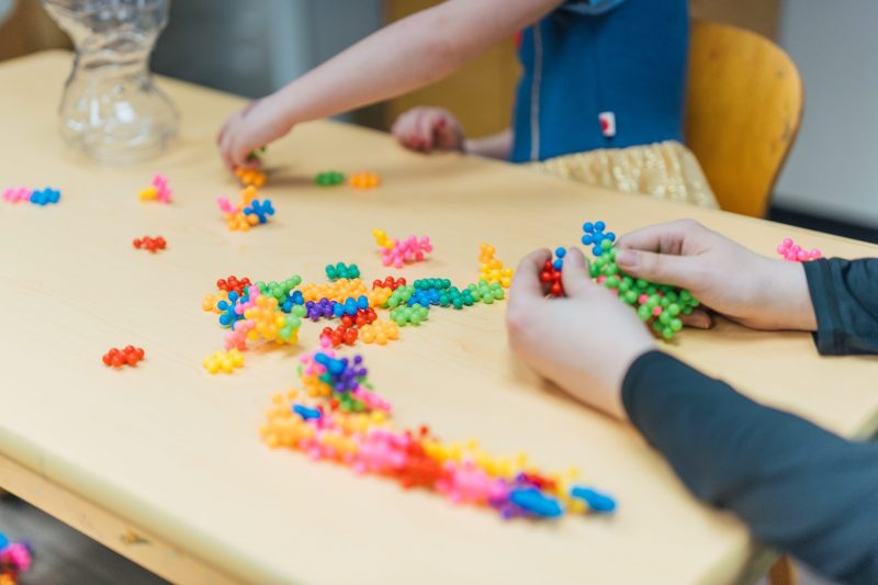 student and a teacher playing with STEM toys for building