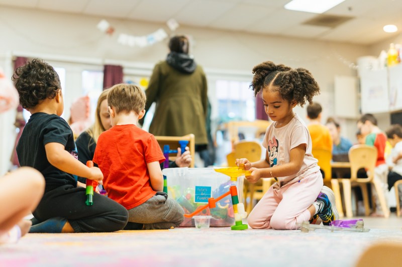 students playing on the floor in the clasroom