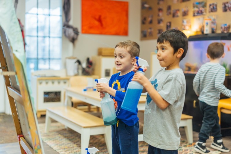 students using spray bottles on an art project