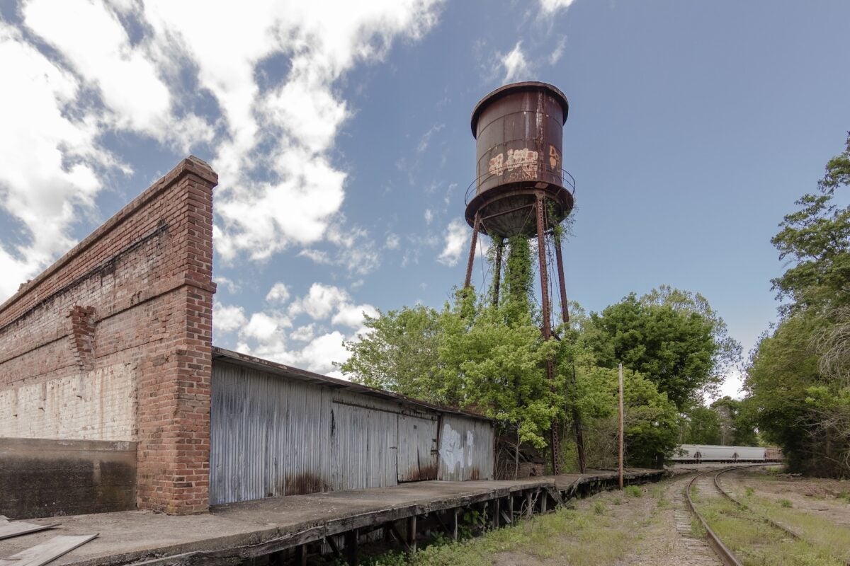 Giant water tower looms of abandoned factory in the deep south
