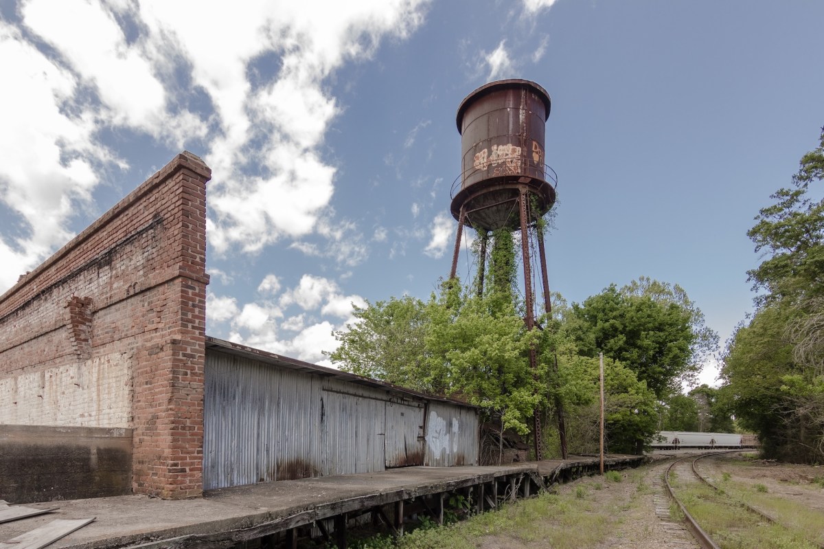 Giant water tower looms of abandoned factory in the deep south