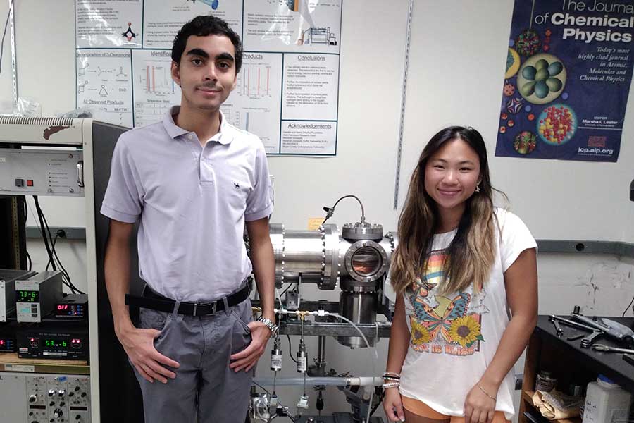 Chemistry summer undergraduate research participants pose in front of the mass spectrometer they helped build