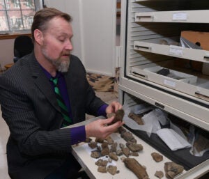 Professor O'Keefe showing some of the fossils found in the field