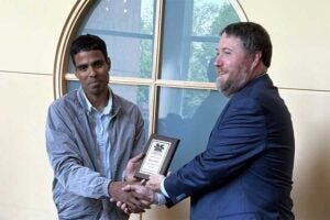 Chemistry faculty Manoj Manna being awarded a Student Success Champion plaque