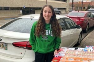Criminal Justice Association president Madilyn delivers donations to Harmony House