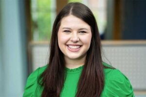 Headshot of College of Science Academic Program Manager and advisor Paige Kennedy wearing a green blouse, photographed indoors against a softly blurred background.