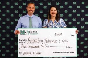 Dr. Stapleton poses with her award from Marshall's iCenter to strengthen student success