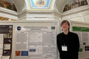 Physics student Tyler Parsons stands with his research poster in the WV Capitol rotunda during Research Day at the Capitol