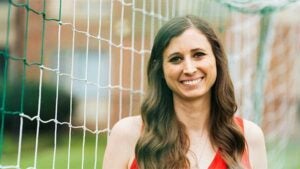 Skye Reymond, 2014 Mathematics graduate, in front of a soccer goal celebrating her work with U.S. Soccer