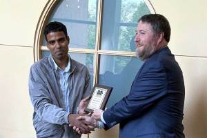 Chemistry faculty Manoj Manna being awarded a Student Success Champion plaque