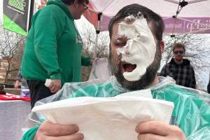 Associate Professor Sean McBride takes a pie in the face for a Pi Day fundraiser
