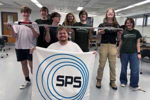 Members of Marshall University's Society of Physics Students chapter pose with an SPS banner and a demonstration apparatus during a planning meeting for the 2026-27 academic year.
