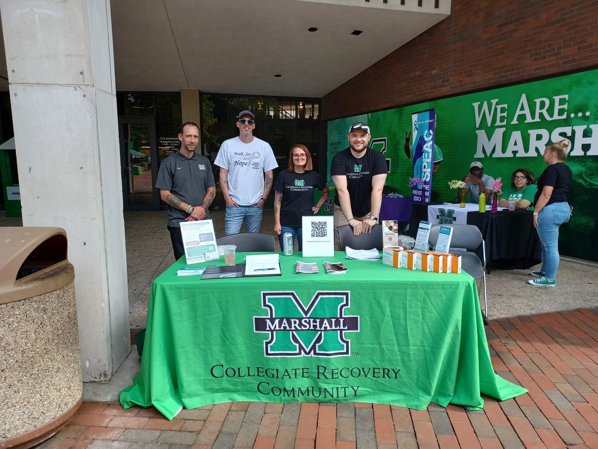Photo of 4 individuals at a table on MSC plaza
