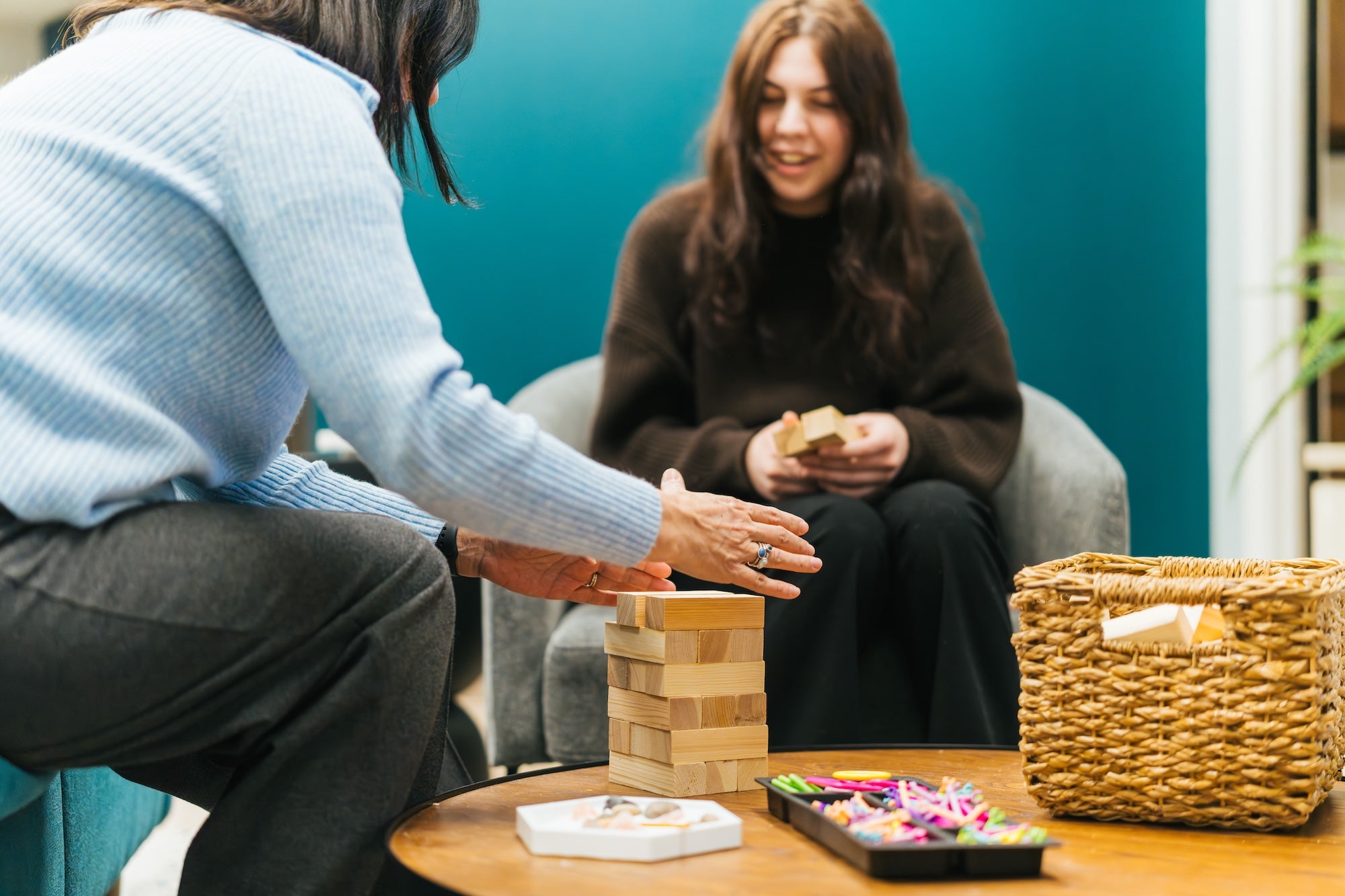Photo of 2 individuals playing Jenga