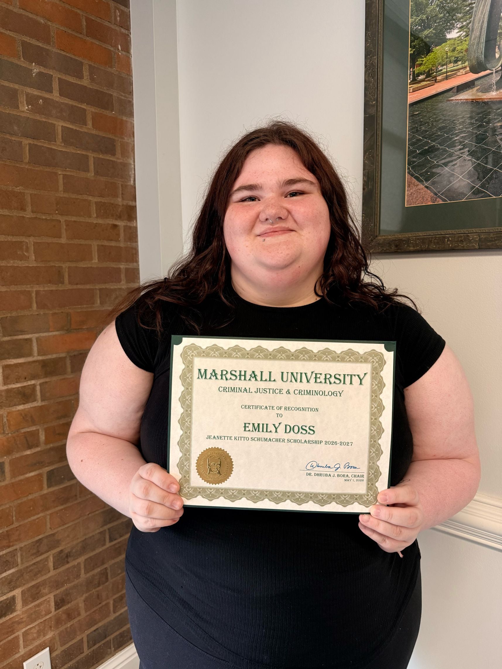 Emily Doss with a certificate
