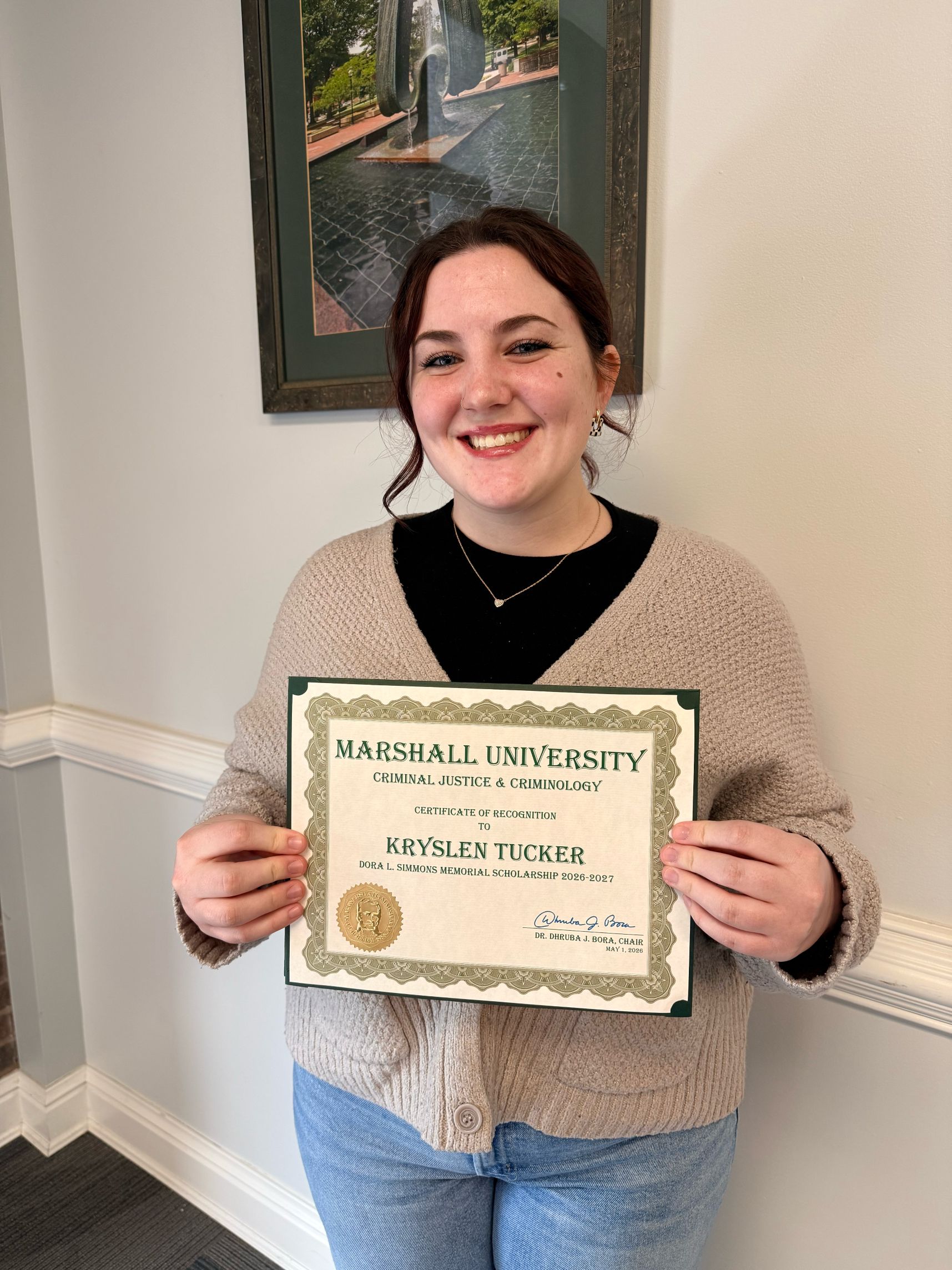 Kryslen Tucker holding a certificate