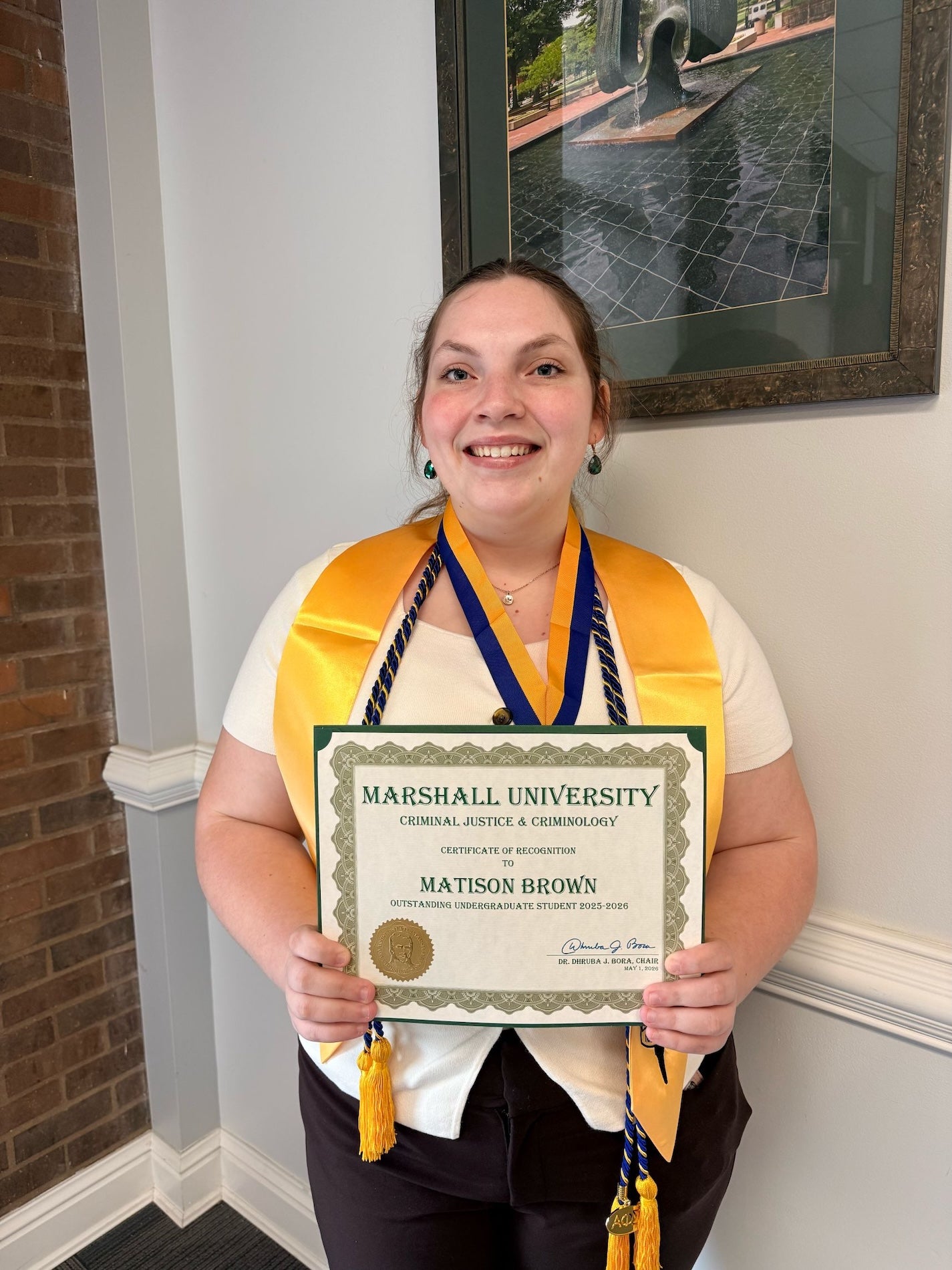 Matison Brown holding an award certificate