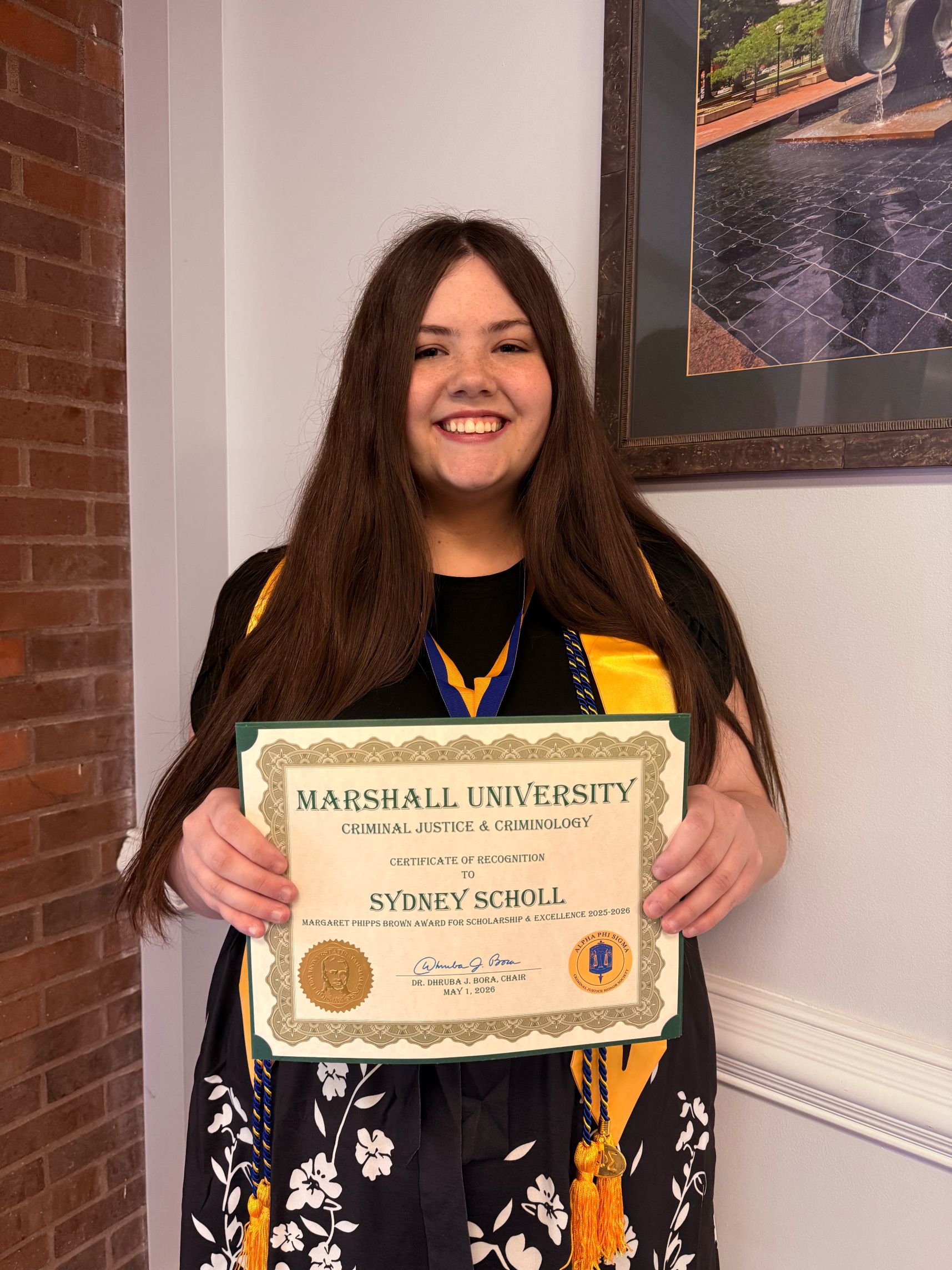 Sydney Scholl with a certificate