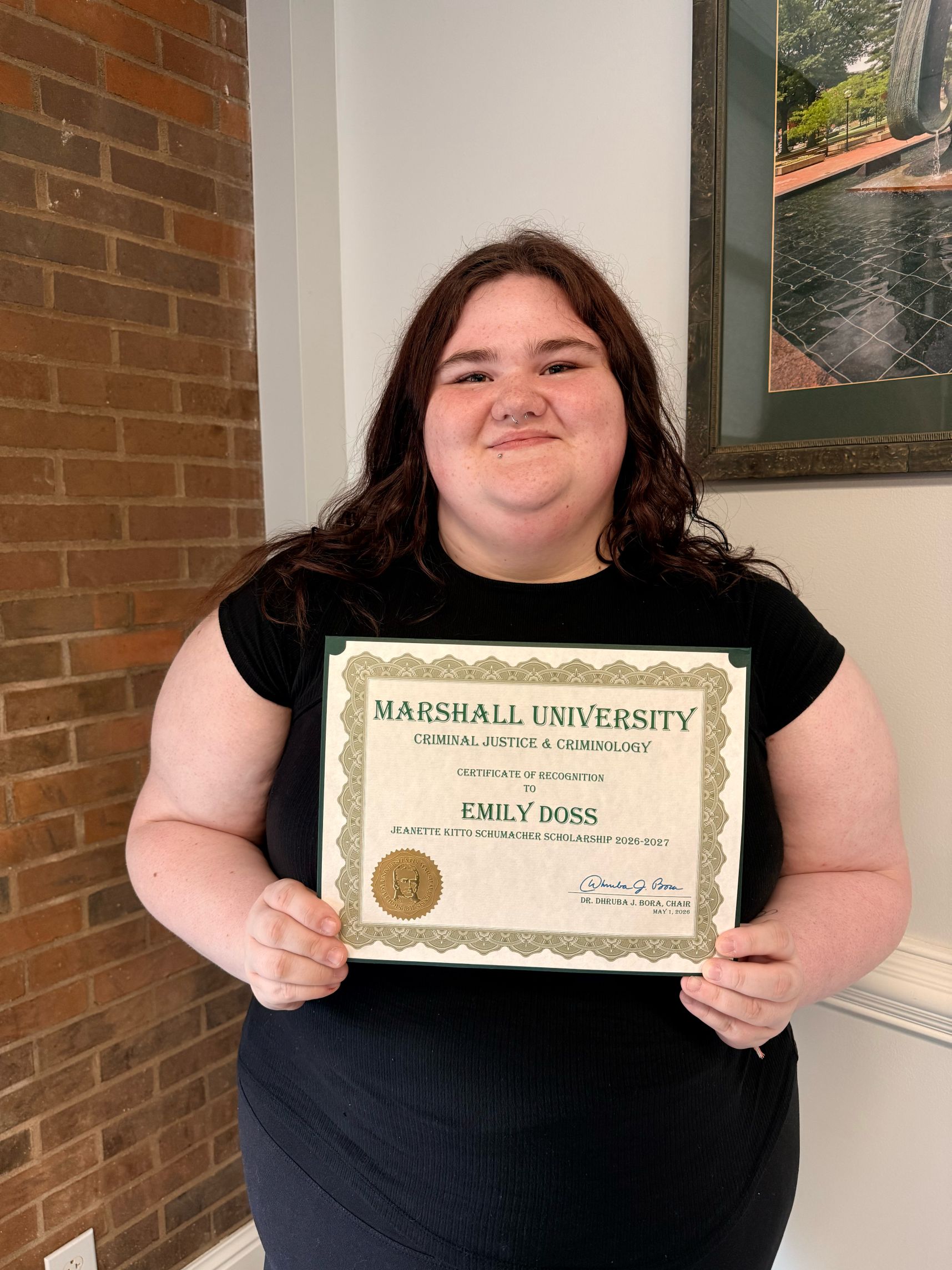 Emily Doss with a certificate