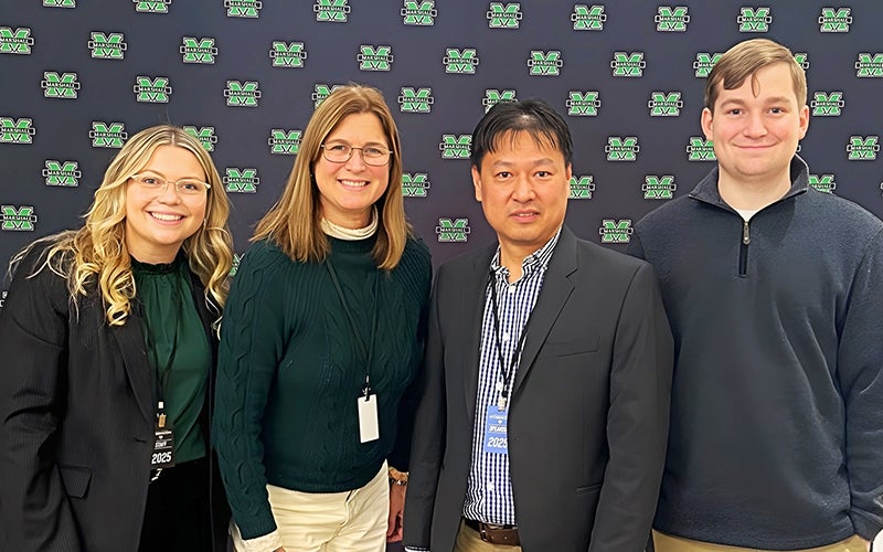 Cyber professionals smile together at a ICS event