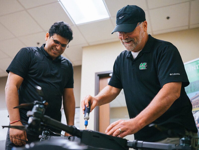 Marshall ICS partners work on a drone together