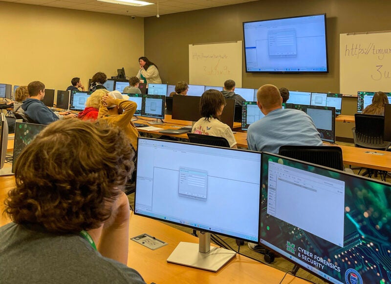 Cyber students work on a computer exercise during a workshop