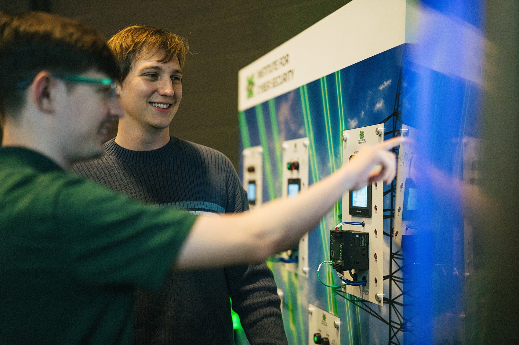 Two students look at the Cyber Hive at Marshall's Institute of Cyber Security