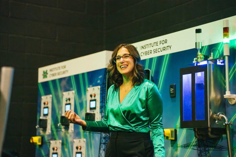 Alexandria Donathan gives a presentation in front of the Cyber Hive at Marshall University's Institute for Cyber Security