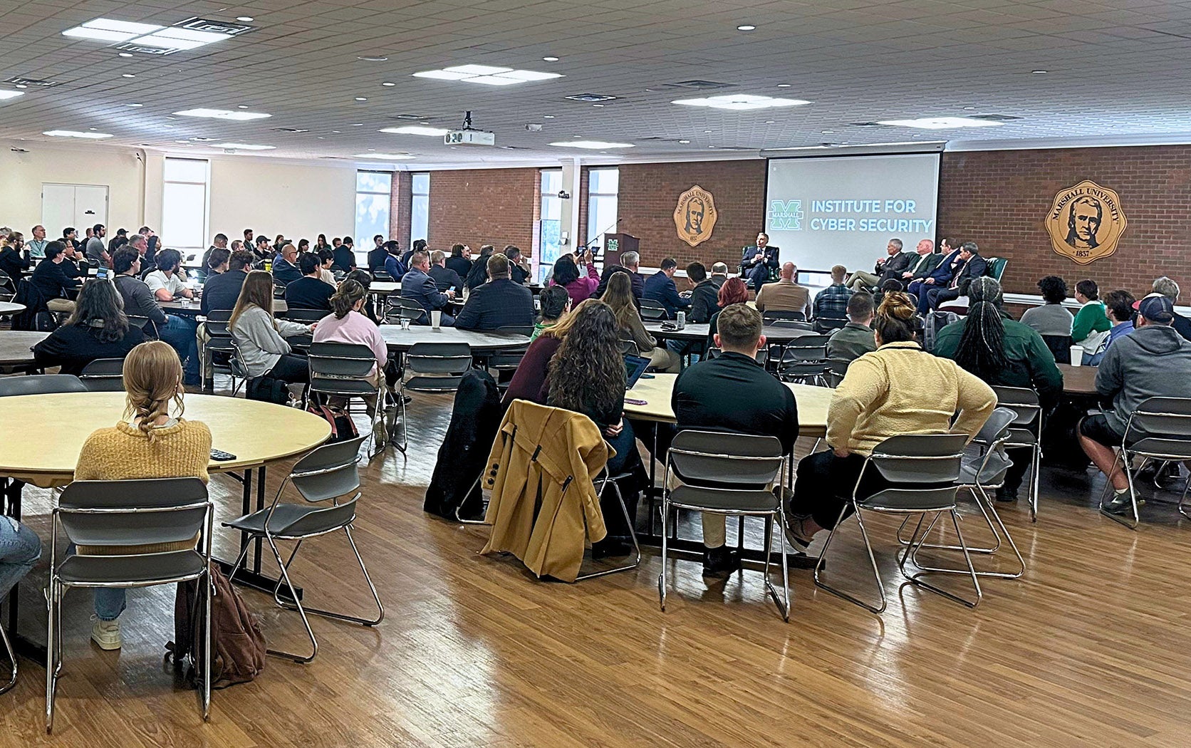 Attendees gather for a panel discussion for Marshall University's CyberCon