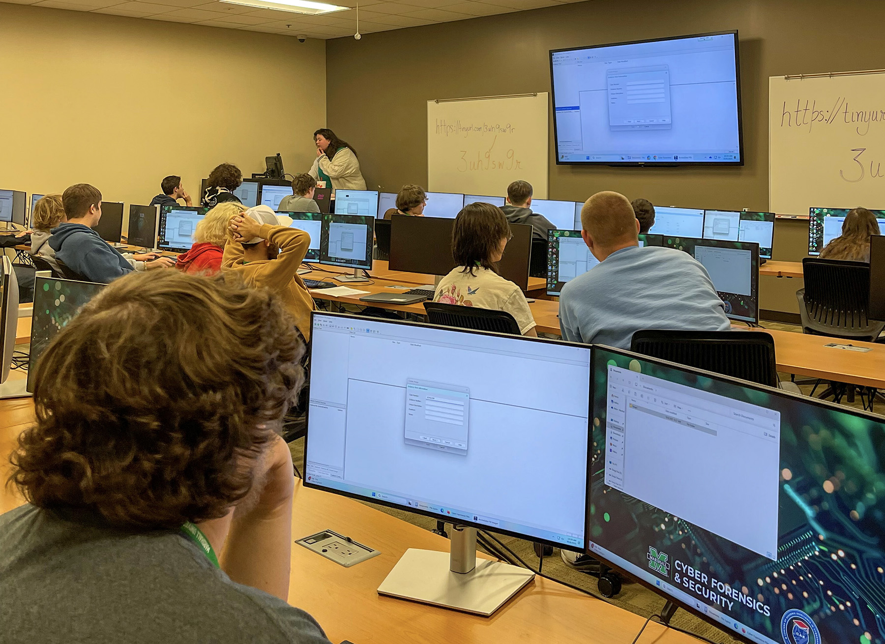 Cyber students work on a computer exercise during a workshop