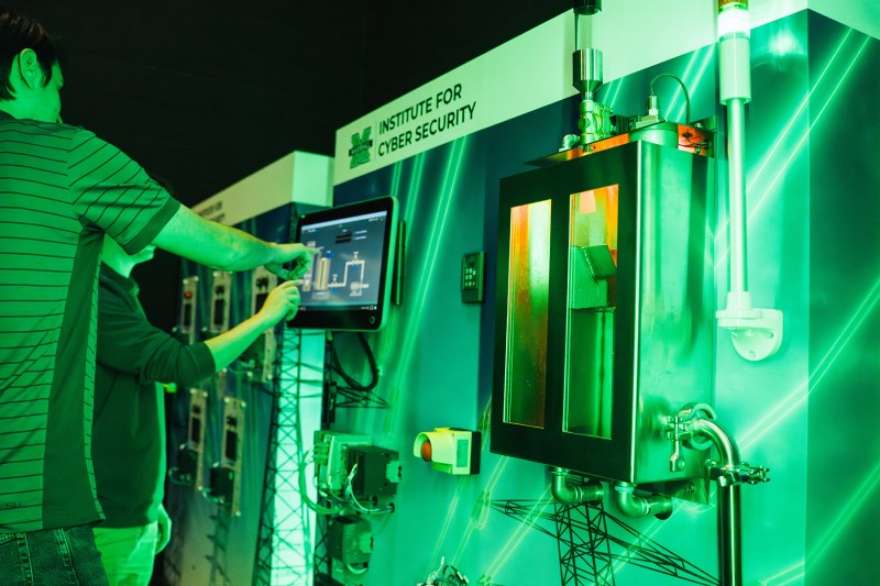 Two people work on a touch screen in the Cyber Hive at Marshall University's Institute for Cyber Security