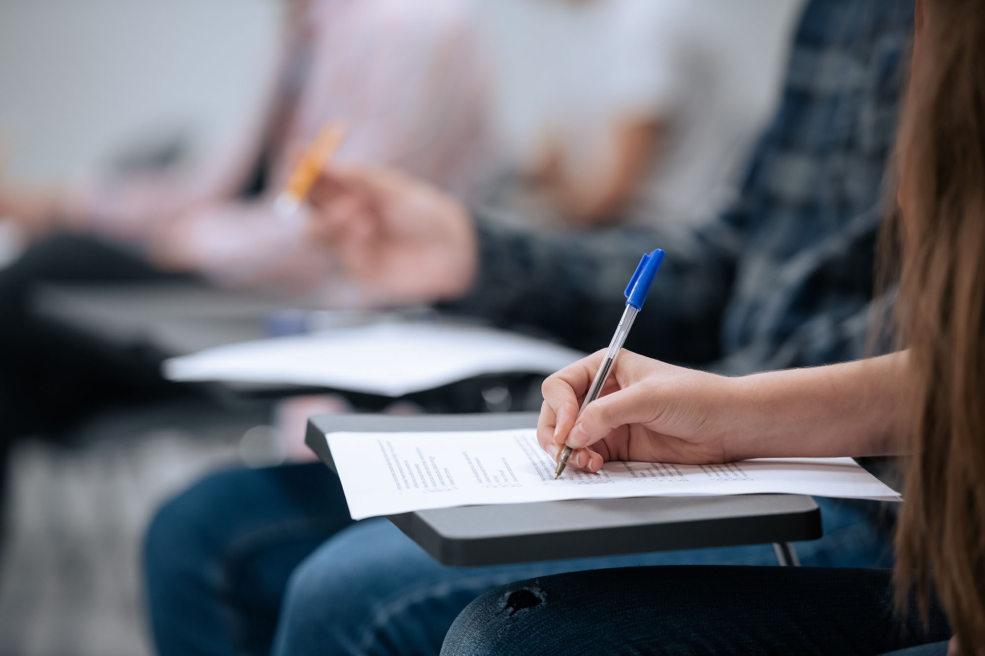 Image of students taking notes in a lecture hall