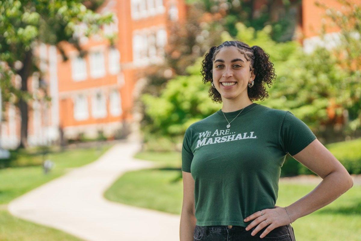 image of student in front of old main