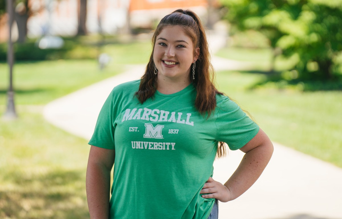 Image of student on campus along walkway