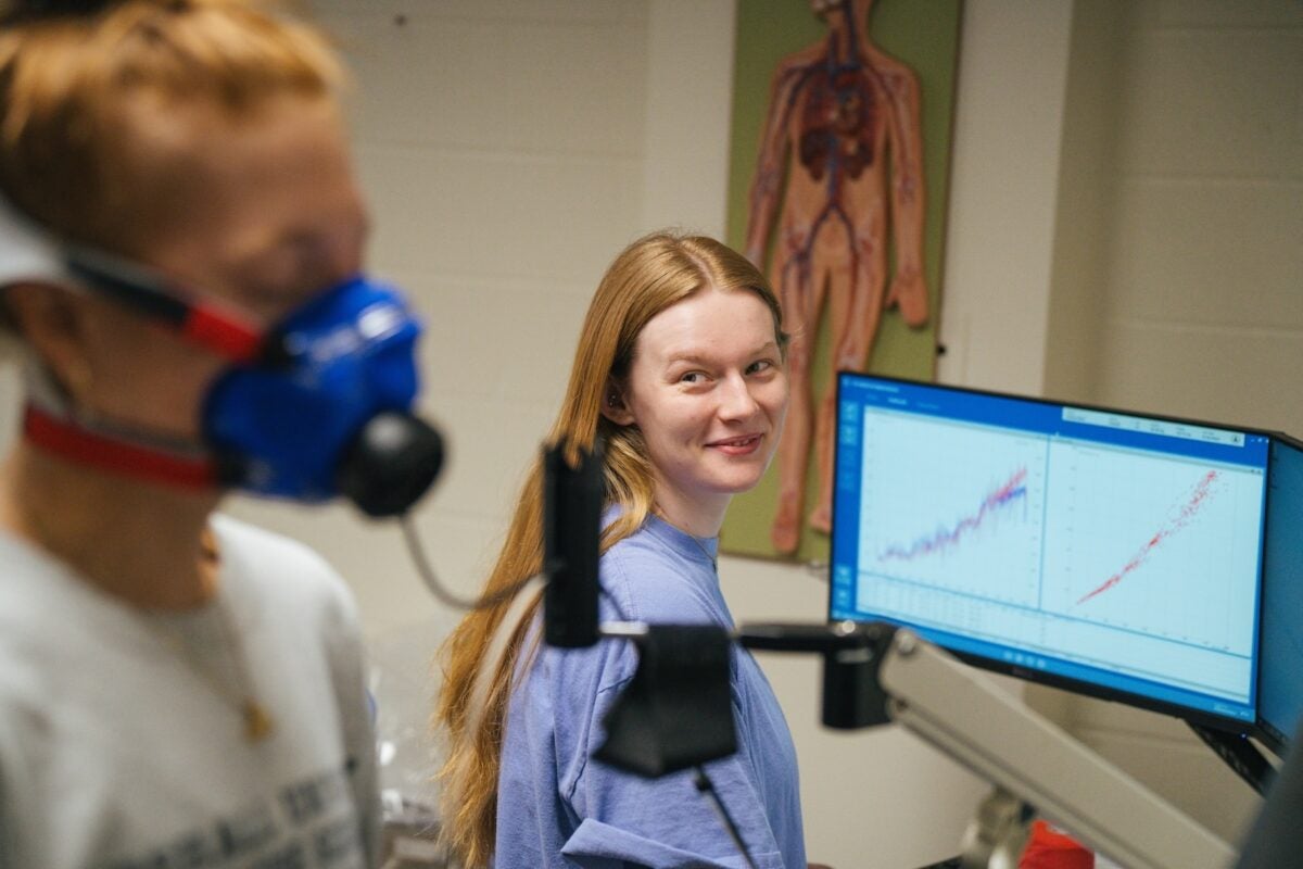 student getting an exercise test in a lab with a student evaluating it on the computer