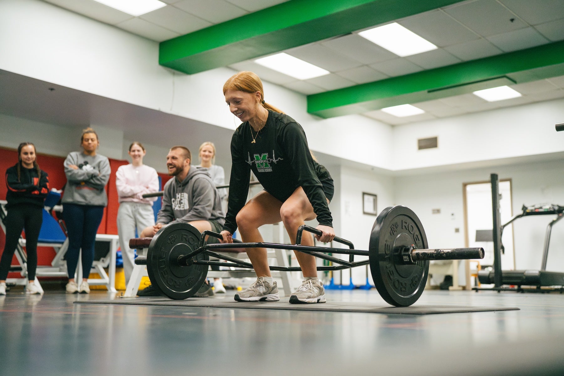 student lifting weights in an exercise science lab