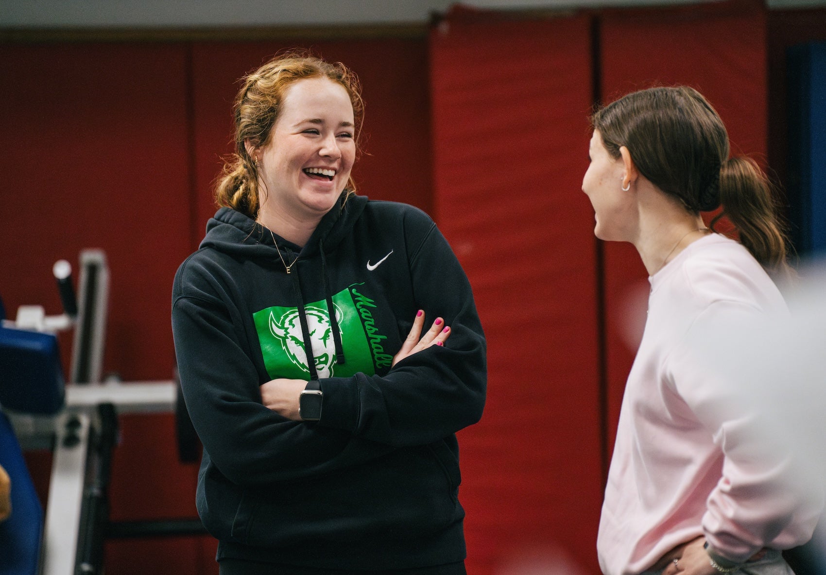 two students talking and laughing in an exercise science lab