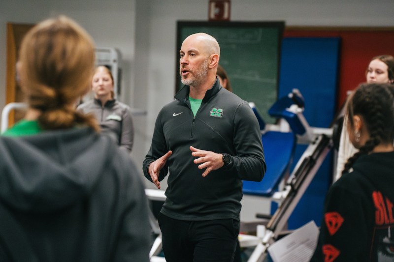 professor teaching a class in the middle of an exercise science lab