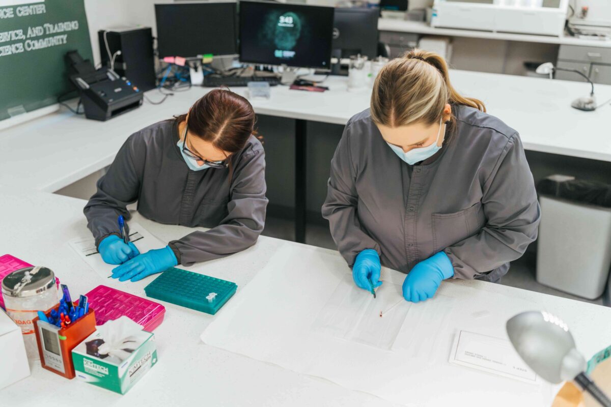 two employees with forensics samples