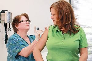 nurse administering shot